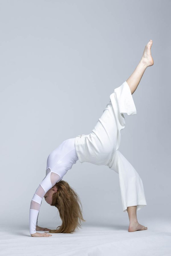 dancer white pants with arched back and stretched legs